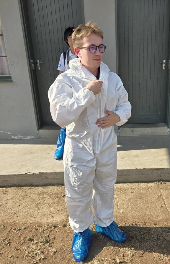 Antoni Mazek entered the farm in protective gear.  Antoni Mazek packed strawberries with farmers for market delivery.