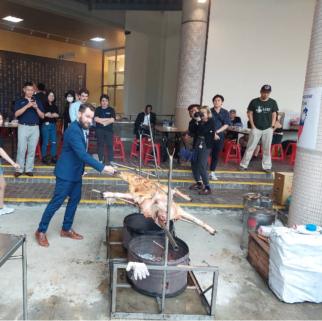 Deputy Representative Jakub Kopecký from the Czech Republic making the first cut on the roasted wild boar.