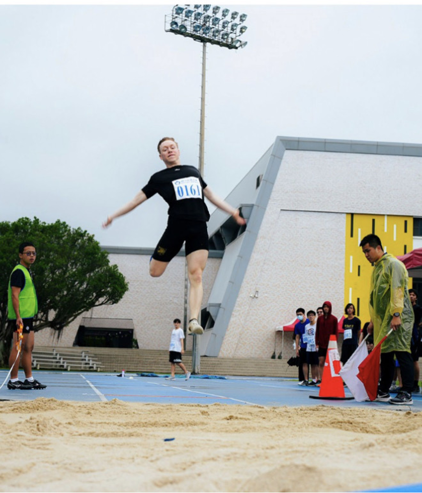 IMAS 1st Year Student, Josiah Spain of the US is long jumping.