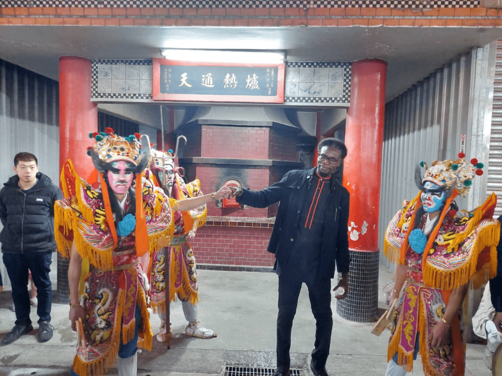 Yimovie Sakue-Collins exchanges fist bumps with the Eight General Gods.