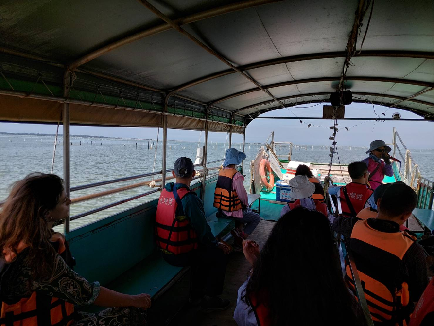 The boat navigated its way through the oyster farm.