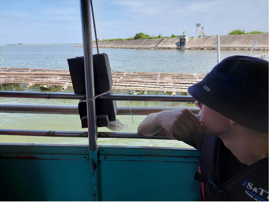 The boat was surrounded by rows of oyster beds.