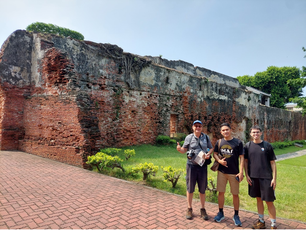 Professor Scott Simon, Stephen Fletes, and IMAS Indonesian student Tinggi Marojahan Sinaga are standing in front of the Fort relics.