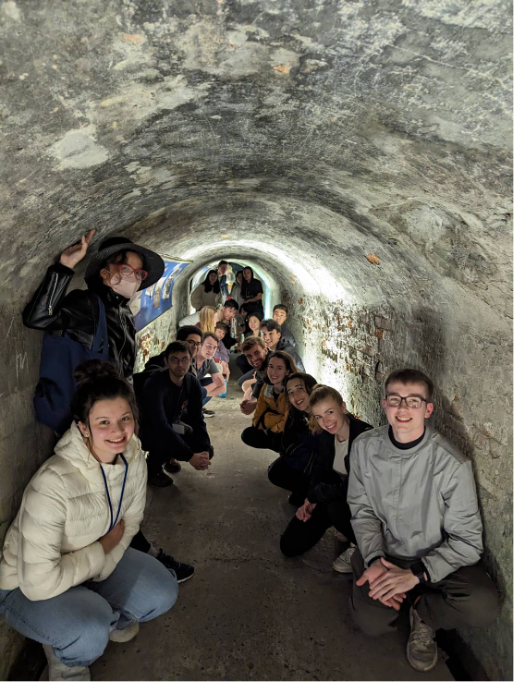 articipants of the joint class gathered in an air raid shelter located within a residential area